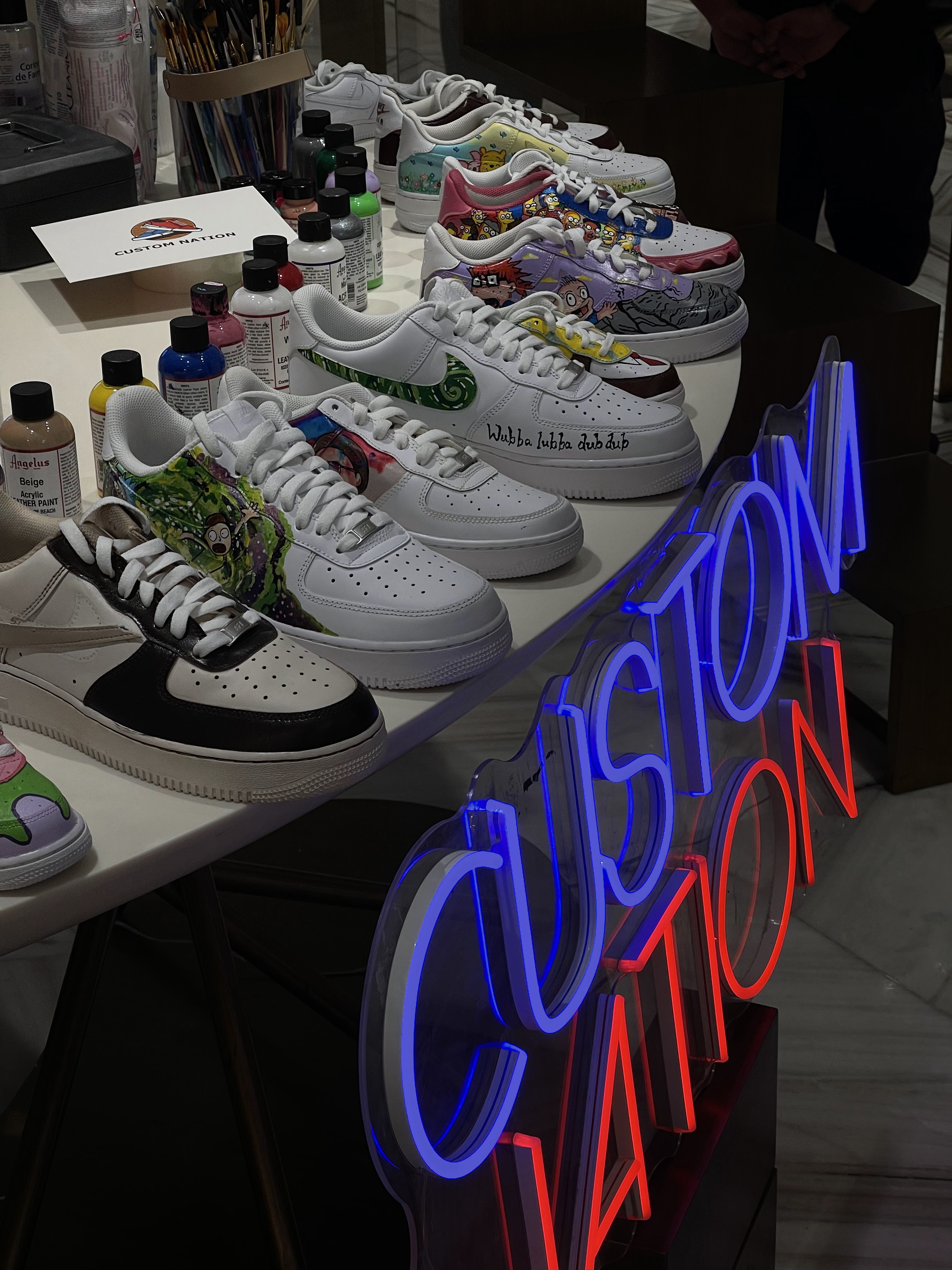 Custom Nation's hand-painted sneakers and paints at the studio display